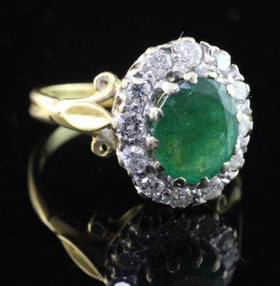 An 18ct gold, emerald and diamond oval cluster ring, size O.